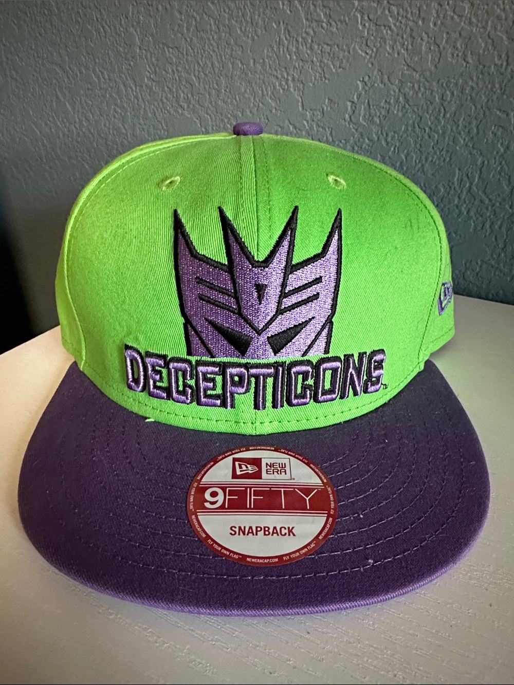 Hat with 'Decepticons' logo and New Era sticker